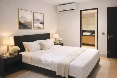 Elegant bedroom with modern decor and ensuite bathroom in luxury apartment.