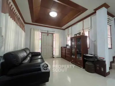 Spacious living room with elegant wooden ceiling and comfortable leather sofa