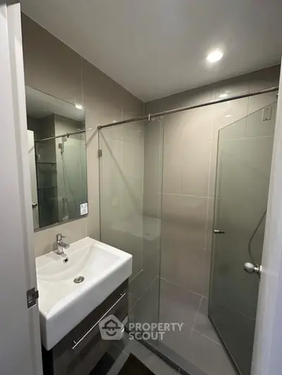 Modern bathroom with glass shower and sleek sink design