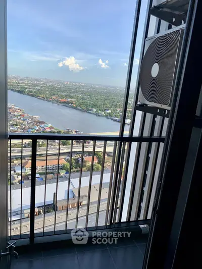 Stunning high-rise balcony view overlooking a river and cityscape, perfect for urban living.