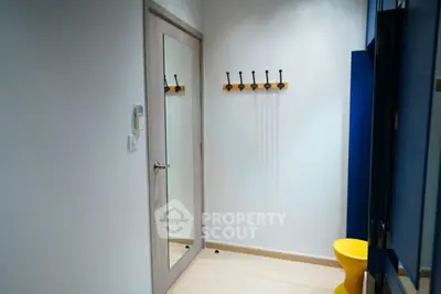 Modern entryway with mirror door and coat hooks in stylish apartment