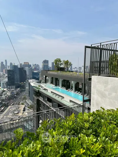 Luxurious rooftop pool with stunning city skyline view in modern high-rise building.