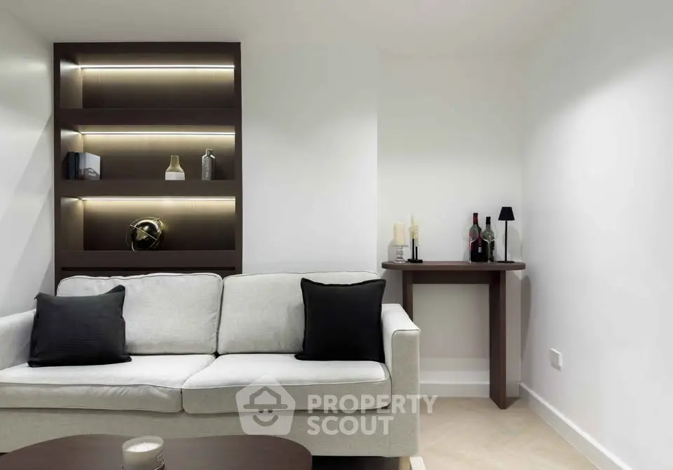 Modern living room with sleek shelving and cozy sofa in minimalist design.