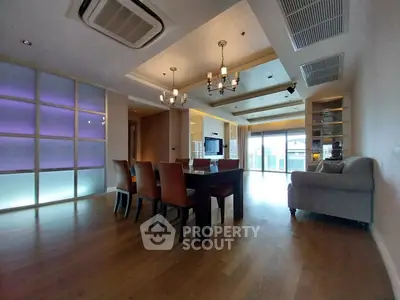 Spacious modern living room with elegant lighting and hardwood floors