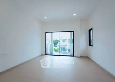 Spacious empty room with large windows and balcony access, perfect for customization.