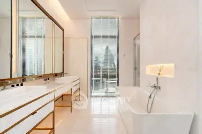 Luxurious bathroom with city view, featuring dual sinks and a sleek bathtub.