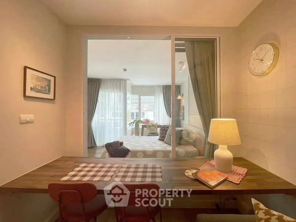 Chic modern living room with dining area and cozy bedroom view