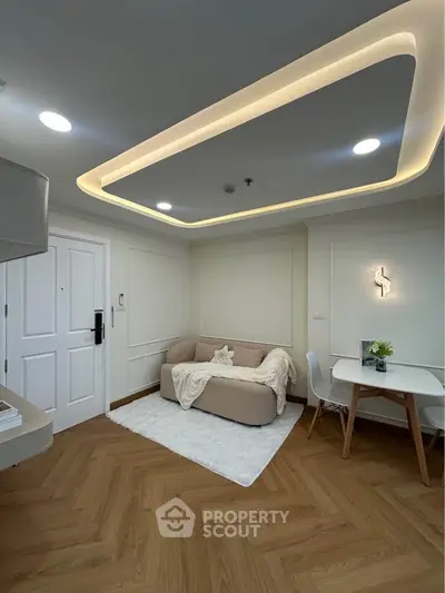 Modern living room with elegant lighting and cozy seating area, perfect for relaxation and entertaining.
