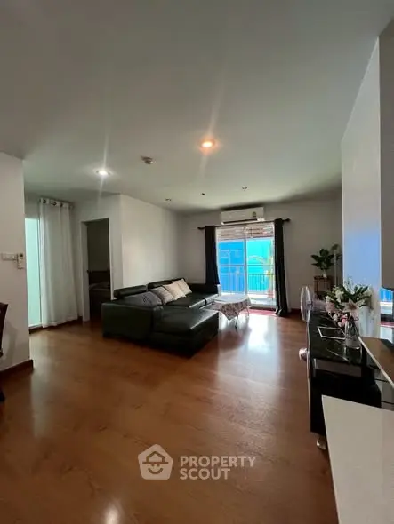 Spacious living room with modern decor and large windows for natural light.