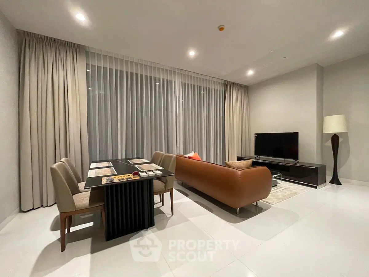 Modern living room with sleek furniture and large windows in a stylish apartment.
