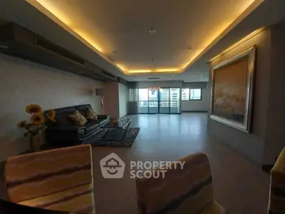 Luxurious living room with elegant lighting and spacious layout, featuring a stunning view from large windows.
