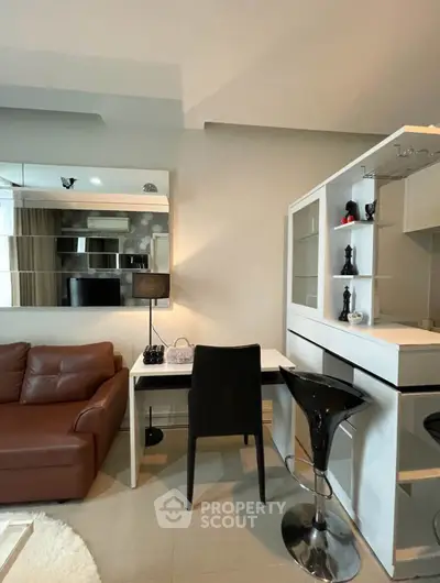 Modern living room with stylish furniture and open kitchen layout