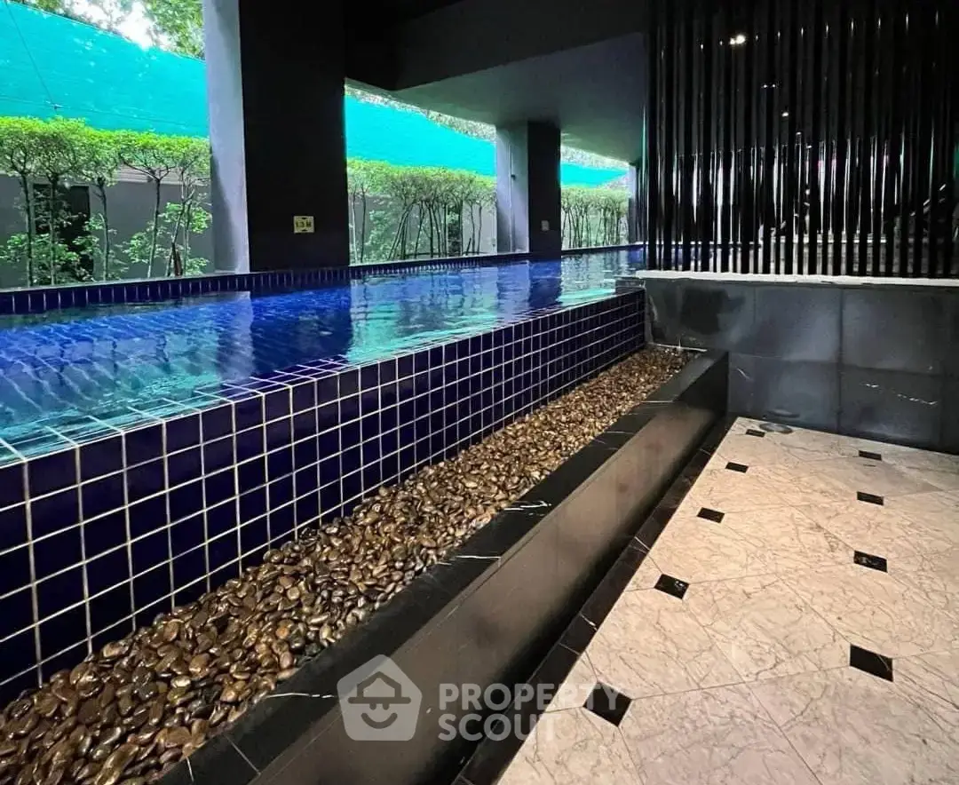 Luxurious indoor pool area with modern design and elegant tile work.
