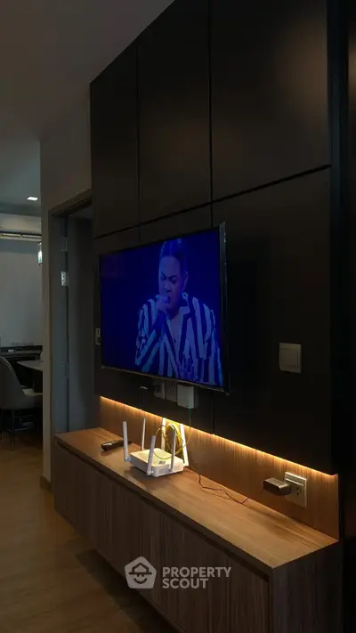 Modern living room with wall-mounted TV and stylish wooden console