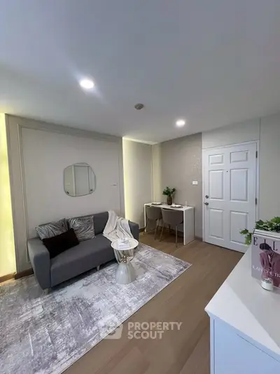 Modern living room with cozy sofa and stylish decor in a contemporary apartment.