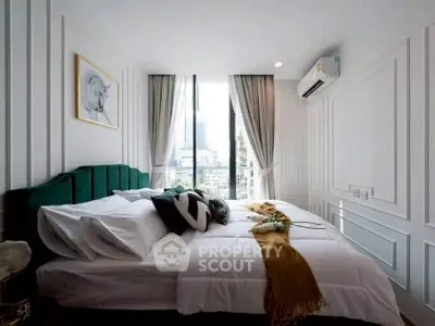 Luxurious bedroom with elegant decor and city view, featuring a plush bed and modern air conditioning.