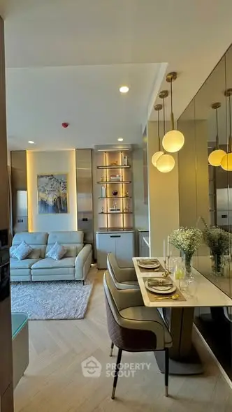 Modern living room with elegant dining area and stylish lighting in a cozy apartment.