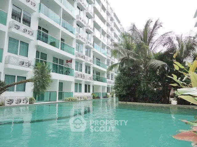 Luxurious condominium with poolside view and lush greenery