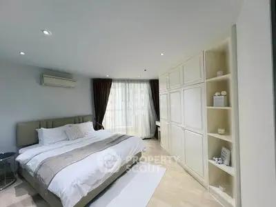 Spacious bedroom with elegant decor and ample natural light
