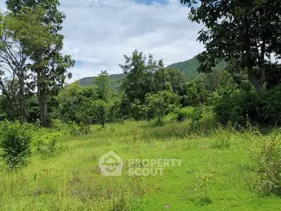 Scenic land plot with lush greenery and mountain views, perfect for development or investment.