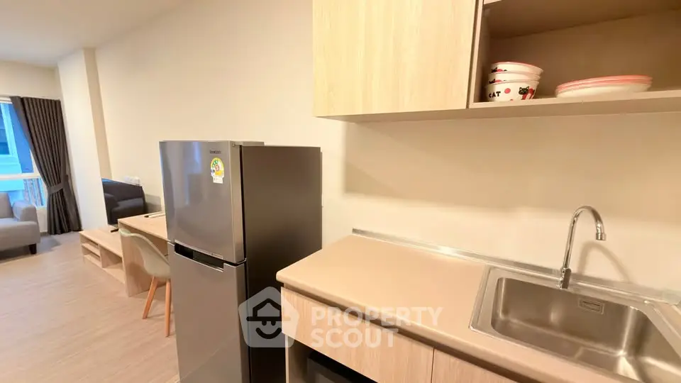 Modern kitchen with sleek appliances and open layout in a stylish apartment.