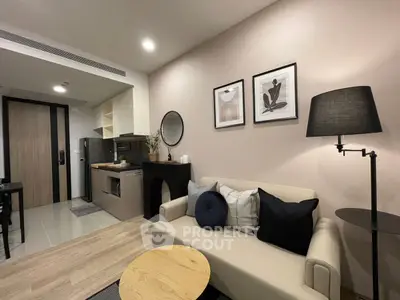 Modern living room with stylish decor and compact kitchen area, perfect for urban living.