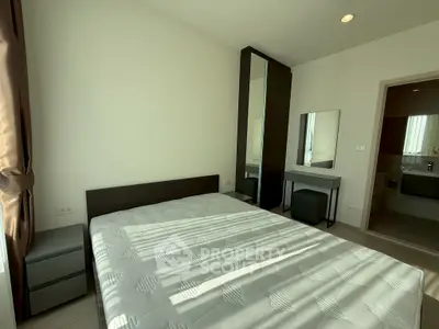 Modern bedroom with natural light, featuring a comfortable bed and stylish furniture, perfect for relaxation.