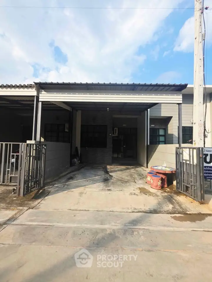 Charming single-story home with gated driveway and covered carport, perfect for modern living.