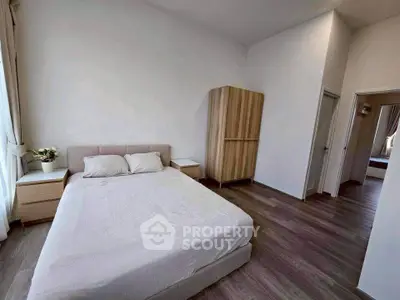 Spacious modern bedroom with minimalist decor and natural light