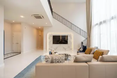 Luxurious modern living room with high ceilings and elegant staircase
