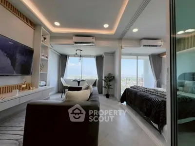 Modern open-plan living room with mountain view and cozy bedroom