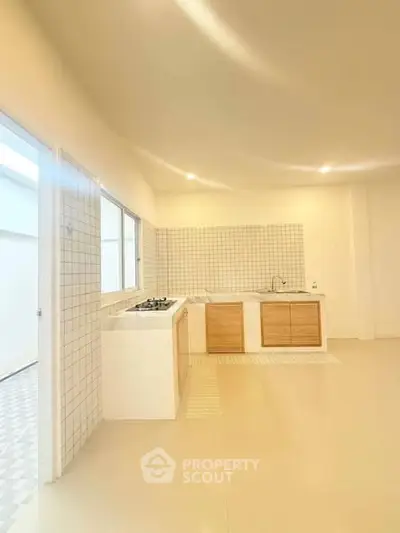 Spacious modern kitchen with gas stove and ample natural light