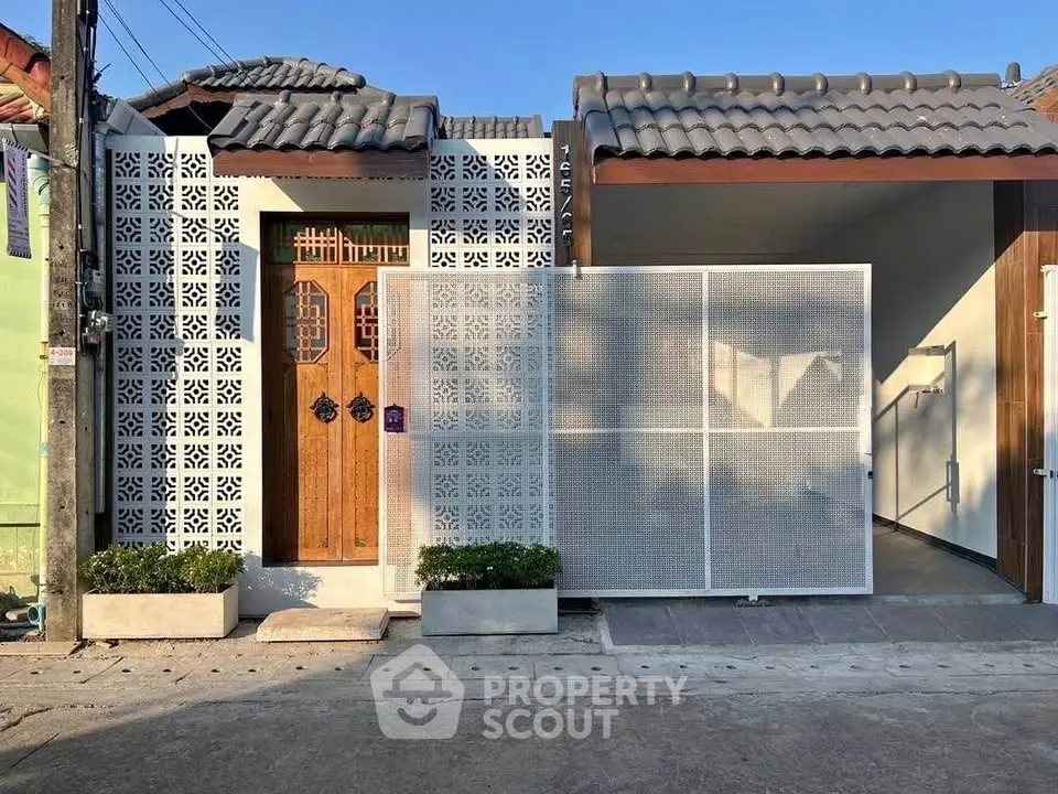 Charming modern house exterior with decorative facade and wooden door, perfect blend of style and privacy.