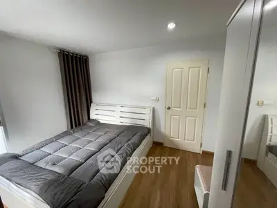 Modern bedroom with sleek design, featuring a cozy bed and stylish wardrobe, perfect for comfortable living.