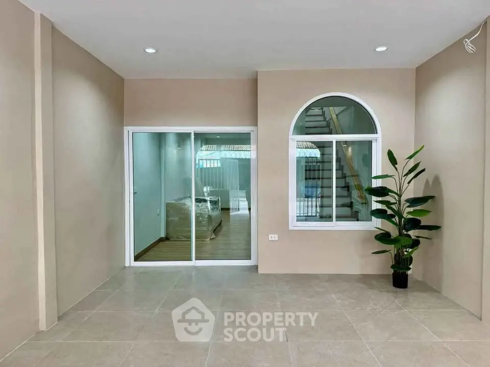 Spacious interior with modern design and large window, perfect for a cozy living area.