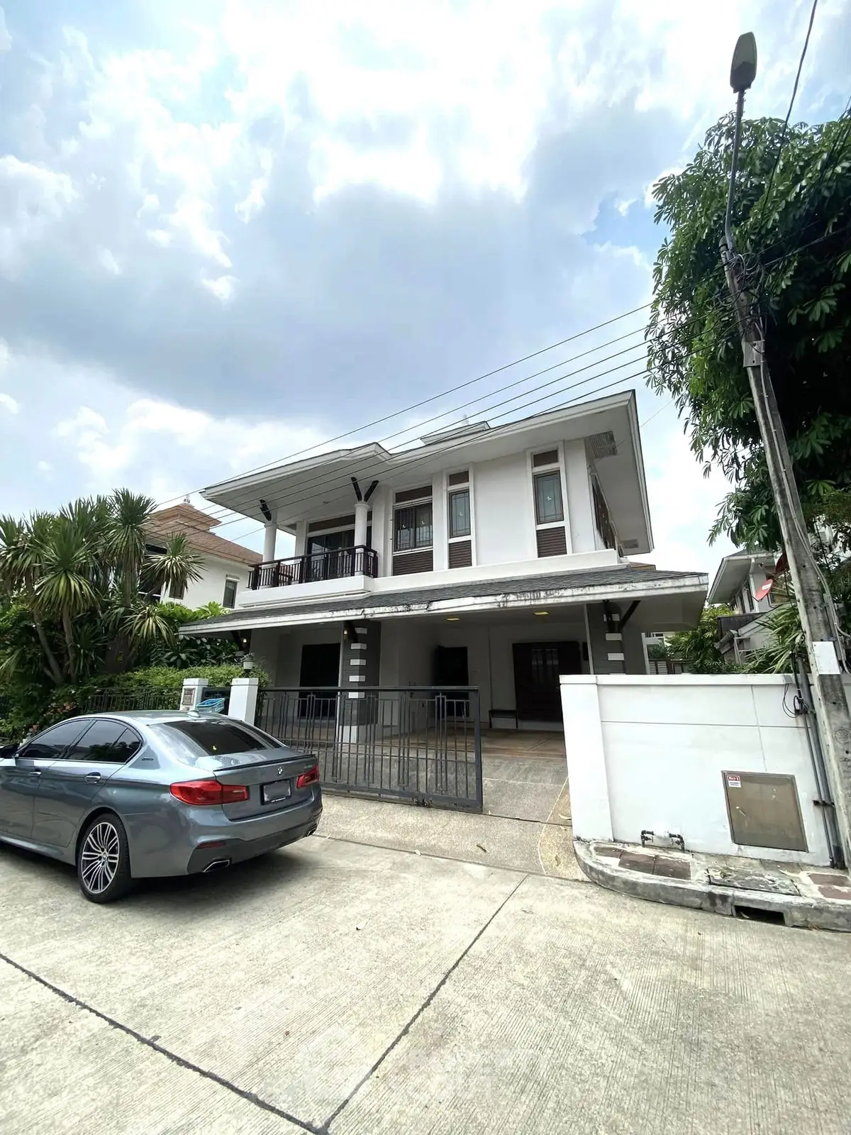 Spacious two-story house with modern design and driveway in a serene neighborhood.