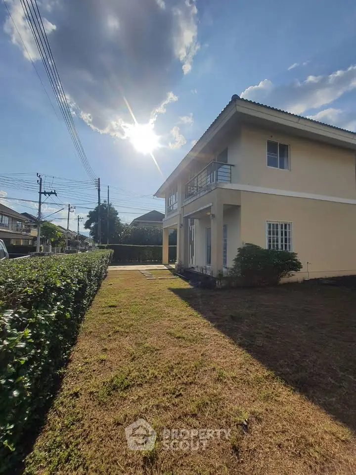 Charming two-story house with lush garden and sunny exterior