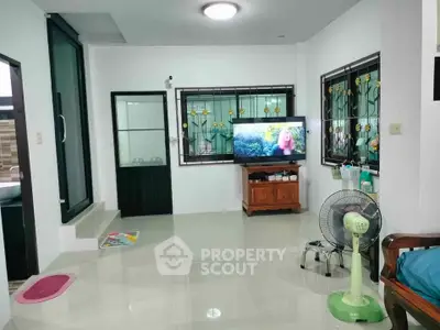 Spacious living room with modern decor and large windows, perfect for relaxation and entertainment.