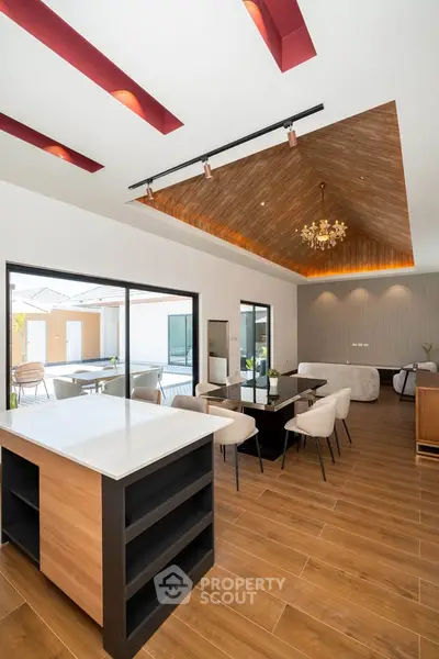 Luxurious open-plan living and dining area with modern design and elegant lighting.
