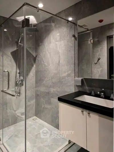 Modern bathroom with sleek glass shower and elegant marble tiles