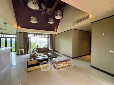 Spacious living room with modern decor and large windows offering scenic views.