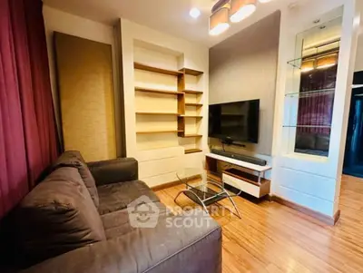 Stylish living room with modern sofa, wall-mounted TV, and elegant shelving.