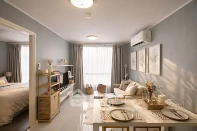 Cozy living room with elegant decor and natural light, adjacent to a stylish bedroom.