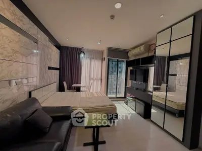 Modern studio apartment with stylish decor and balcony view