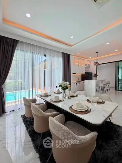 Luxurious dining area with elegant decor and pool view in modern home