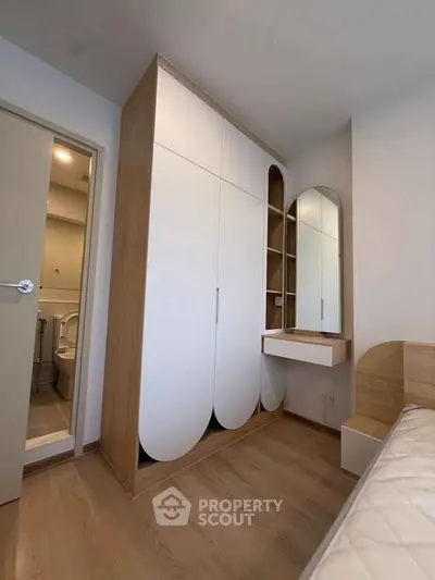 Modern bedroom with stylish wardrobe and vanity in minimalist design