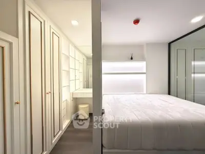 Modern bedroom with sleek white design and built-in storage solutions