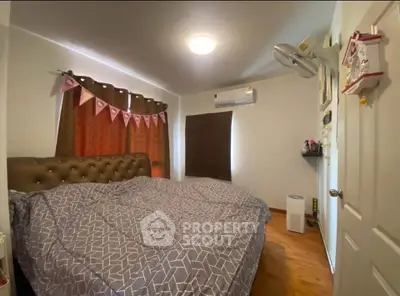 Cozy bedroom with modern decor and air conditioning, perfect for relaxation.