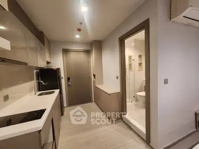 Modern apartment kitchen with sleek cabinetry and integrated appliances