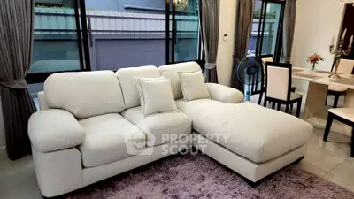 Luxurious living room with plush sectional sofa and elegant dining area, perfect for modern comfort and style.